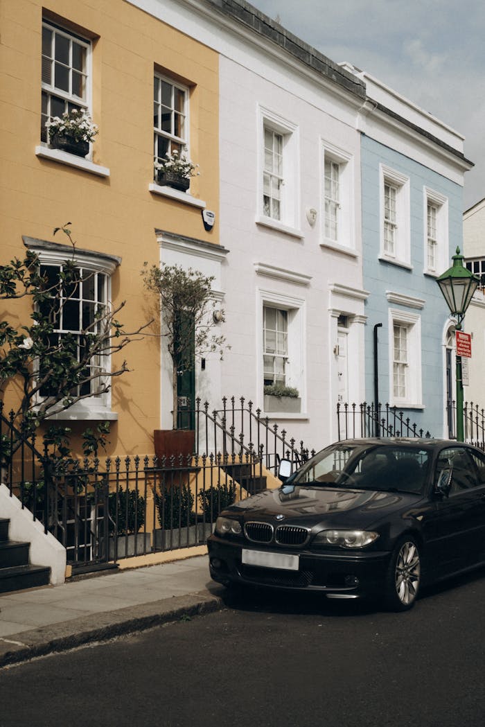 Vibrant pastel townhouses on a sunny London street in Notting Hill.